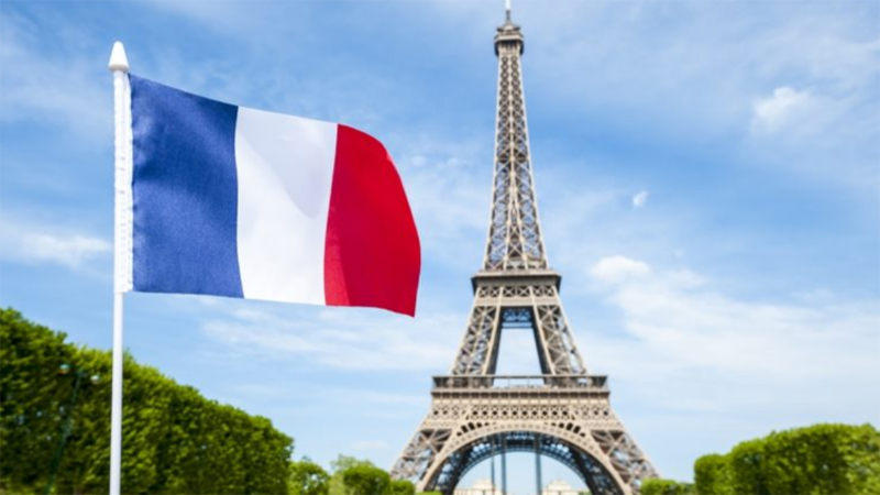 a flag in front of a tower